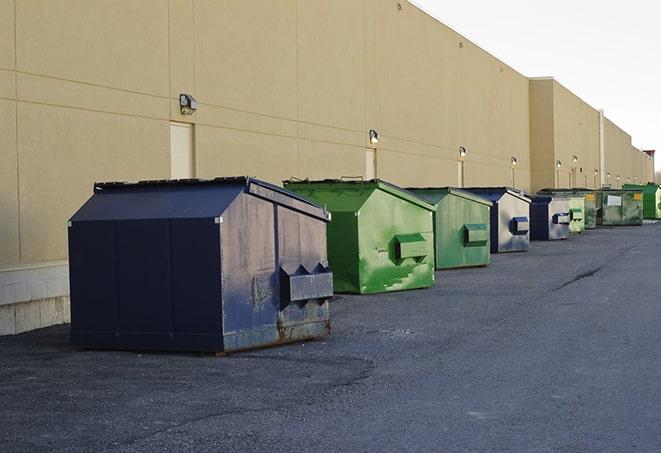 a stack of yellow construction dumpsters on a job site in Mapleton